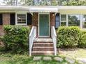 Inviting front entrance with brick steps, white railings, and a lovely green door at 114 Brenrose Cir, Durham, NC 27705