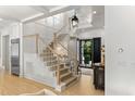 Bright foyer with staircase, beautiful chandelier, and wood-paneled walls at 115 Founders Ridge Dr, Chapel Hill, NC 27517