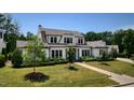Beautiful two-story home with a well-maintained lawn and professional landscaping at 115 Founders Ridge Dr, Chapel Hill, NC 27517