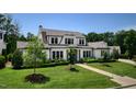 Stunning two-story home boasting a manicured lawn, mature trees, and classic architectural design at 115 Founders Ridge Dr, Chapel Hill, NC 27517