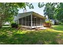 Spacious screened-in porch perfect for outdoor relaxation and entertainment, surrounded by a lush green backyard at 115 Heatherwood Dr, Apex, NC 27502