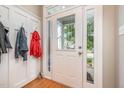 Bright entryway features coat hooks, hardwood floors, and a front door with sidelights at 1230 Golden Bluff Ln, Fuquay Varina, NC 27526