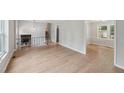 Spacious living area with hardwood floors, staircase, and a view to the fireplace and dining area at 1308 Swallow Dr, Raleigh, NC 27606
