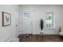 Bright entryway featuring white walls, hardwood floors, and a charming floral rug at 1318 N Alston Ave, Durham, NC 27701