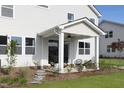 Inviting outdoor patio with stylish seating and a well-maintained yard, ideal for relaxation and entertaining at 157 Vaughan Farms Drive Dr, Angier, NC 27501