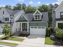 Attractive two-story home displaying a well-maintained lawn, neutral paint, and an attached garage at 167 Monteith Dr, Chapel Hill, NC 27516