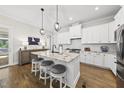 Gourmet kitchen features a marble island, pendant lighting, and stainless steel appliances at 167 Monteith Dr, Chapel Hill, NC 27516