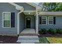 Close-up of the front entrance, featuring a black door, white trim, and the house number at 169 Forest Dr, Graham, NC 27253