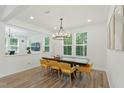 Sunlit dining room featuring a modern chandelier and an inviting wood dining table at 187 Harpers Landing Rd, Garner, NC 27529