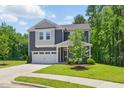 Attractive two-story home featuring a manicured lawn and a convenient two-car garage at 187 Harpers Landing Rd, Garner, NC 27529