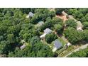 Wide aerial shot displaying the home's neighborhood and surrounding lush greenery at 2310 Turning Pointe Way, Hillsborough, NC 27278
