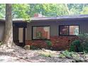 Charming single-story home with a brick accent, mature trees, and natural landscaping at 26 Mt. Bolus Rd, Chapel Hill, NC 27514