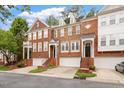 Charming townhomes featuring brick exteriors, front-entry garages, and manicured landscaping in a desirable neighborhood at 2614 Laurelcherry St, Raleigh, NC 27612