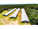 Aerial view of a property featuring several agricultural buildings, revealing their layout and surroundings at 2642 Holly Springs Church Rd, Broadway, NC 27505