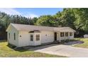 A lovely single-story home shows off a bay window, covered porch, and paved driveway in a serene, wooded neighborhood at 282 Cooke Rd, Louisburg, NC 27549