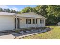 This ranch home boasts a covered front porch, landscape lighting, and a peaceful setting, perfect for relaxing outdoors at 282 Cooke Rd, Louisburg, NC 27549