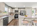 Modern kitchen featuring stainless steel appliances, granite countertops, and a breakfast bar with seating at 303 Rothbury Ct, Sanford, NC 27330