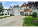 Street view of homes displaying their manicured lawns, driveways, and welcoming facades at 306 Berlin Way, Morrisville, NC 27560