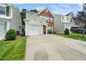 Home exterior with driveway, one car garage, and well-kept front lawn at 306 Berlin Way, Morrisville, NC 27560