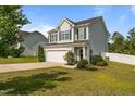 Charming two-story home with a two-car garage and a well-manicured lawn at 315 Watchmen Ln, Cameron, NC 28326