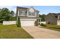 Charming two-story home with a two-car garage and manicured lawn with mature landscaping at 315 Watchmen Ln, Cameron, NC 28326