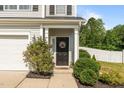 Inviting front entrance with a decorative wreath and manicured landscaping at 315 Watchmen Ln, Cameron, NC 28326