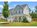 Charming two-story home with a manicured lawn and landscaping at 33 E Ravano Dr, Clayton, NC 27527