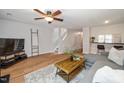 Open-concept living room boasts wood floors, comfortable seating, and a breakfast bar, perfect for modern living at 4604 Townesbury Ln, Raleigh, NC 27612