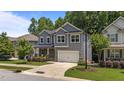 Two-story home with gray siding and a two-car garage complements the green lawn at 516 Culmore Dr, Fuquay Varina, NC 27526