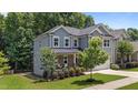 Landscaped two-story home featuring gray siding, a manicured lawn, and a two-car garage at 516 Culmore Dr, Fuquay Varina, NC 27526