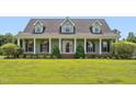 Inviting traditional home with a spacious front porch, white columns, and meticulously manicured lawn at 5405 Overdale Ln, Raleigh, NC 27603