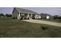 Inviting home with manicured lawn and driveway leading to ample parking spaces, showcasing curb appeal at 60 Falling Leaf Ln, Benson, NC 27504