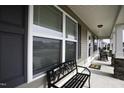 Welcoming front porch adorned with stylish bench and rocking chairs, perfect for relaxation and enjoying outdoors at 60 Falling Leaf Ln, Benson, NC 27504