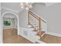 Traditional entryway featuring a staircase, hardwood floors, and decorative moldings at 6201 Bayswater Trail Trl, Raleigh, NC 27612