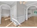 A bright, open living space with hardwood floors, white trim, and archways at 6201 Bayswater Trail Trl, Raleigh, NC 27612