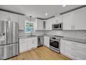 Modern kitchen with white cabinets, stainless steel appliances, and granite countertops at 6328 Jones Farm Rd, Wake Forest, NC 27587