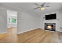 Inviting living room with a fireplace, ceiling fan, and hardwood floors at 6328 Jones Farm Rd, Wake Forest, NC 27587