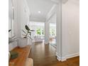 Bright foyer showcasing hardwood floors, white trim, and an inviting view into the living spaces at 74 Permit Ct, Chapel Hill, NC 27517