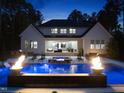 Backyard pool with a fire feature creating a relaxing and luxurious outdoor space at 7545 Hasentree Club Dr, Wake Forest, NC 27587