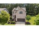 Attractive brick home with a well-manicured front yard, and a welcoming entryway at 8132 Wheeler Woods Dr, Apex, NC 27539