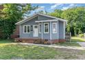 Charming home with gray siding, a brick foundation, and a small staircase at 828 Cotton Pl, Raleigh, NC 27601