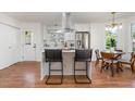 Kitchen area with stainless steel appliances, island with seating, and adjacent dining area at 828 Cotton Pl, Raleigh, NC 27601