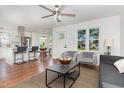Open-concept living room boasts ample natural light, modern decor, and hardwood floors at 828 Cotton Pl, Raleigh, NC 27601