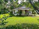 Charming one-story home surrounded by a lush green lawn and mature trees, offering a peaceful setting at 912 E Pope St, Dunn, NC 28334
