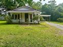 Inviting one-story home with a well-maintained front lawn, covered porch, and convenient carport at 912 E Pope St, Dunn, NC 28334