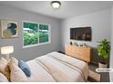 Comfortable staged main bedroom with natural light, modern furnishings, and stylish decor creating a relaxing retreat at 916 Waring St, Durham, NC 27704