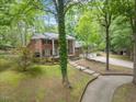 Stunning brick home with an attached three car garage and a front yard with mature landscaping at 9801 Honeycutt Rd, Raleigh, NC 27614