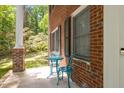 Cozy porch featuring a small table and chairs, perfect for enjoying a morning coffee at 9801 Honeycutt Rd, Raleigh, NC 27614