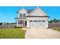 Inviting two-story home with a covered front porch and an attached two-car garage at 102 Williamson Place Dr, Princeton, NC 27569