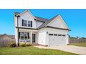 Attractive two-story home with a welcoming porch and an attached two-car garage at 102 Williamson Place Dr, Princeton, NC 27569
